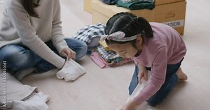 Small gift donate for social issue relief alms unity care at home. Asia little girl kid and mom happy smile help poor people by reuse old used clean clear closet sort stack box zero waste eco saving.