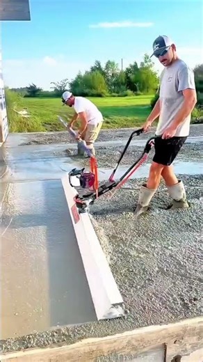 Man using a vibratory power screed