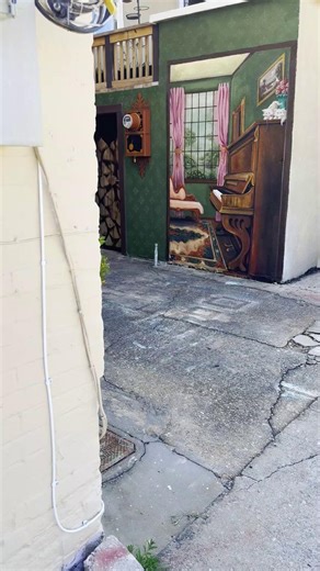 Step back in time at the Victorian Parlor Mural behind Main Street Antiques in Historic Downtown Panama City. Painted by Heather Parker, this incredible mural features countless hidden details that capture your attention and imagination. Find it on the Panama City Mural Trail. #LovePC #ArtCityPC