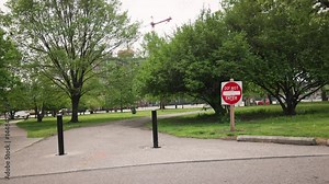 Red and white do not enter traffic and pedestrian sign signaling a blocked and closed route down a path and road roadway, blocking people, cars, and vehicles from entering due to closure in area