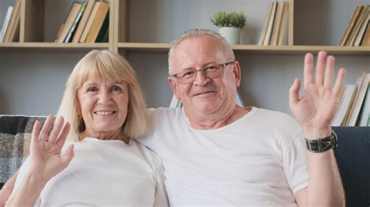 Elderly couple waving hello at camera while chatting on a video call - Free Stock Video