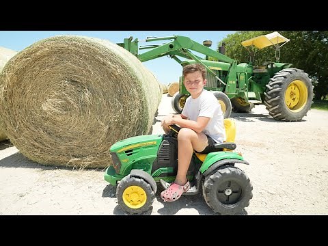 Hudson Uses Real Tractors and Kids Tractors to Make Hay