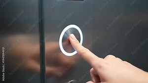 Close up of a finger pressing an elevator button.