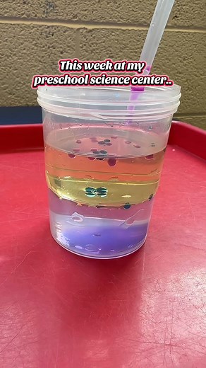 This week at our preschool science center, the first tray features a cup half-filled with water and half with oil, plus two cups of liquid watercolor (diluted with water) and eyedroppers. It’s fascinating to watch the colored water drop through the oil, form a little bubble, then sink and mix with the water below. We also placed some sensory bottles in the middle. On the second tray, there’s a large teeth model with a big toothbrush so students can practice brushing. Fun and hands-on for both sc