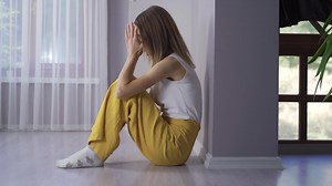 Premium stock video - Depressed woman crying on the floor.