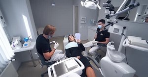 Female patient laying in dentist chair.