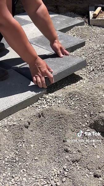 Laying the Pavers One Painful Surprise Once the base was solid and perfectly flat, I started laying down the pavers—12x12 in two colors: light gray and dark gray, arranged in a checkered pattern. You can find these pavers at Home Depot if you’re in the U.S. As I worked, I kept using a leveler to make sure everything stayed nice and even. But here’s the tough part: the edges. To finish the perimeter, I had to cut the pavers into triangles—and that was no joke. After trying a few things, I found a