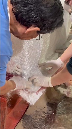 Laying up fiberglass by hand and rolling in resin to fully wet out the laminate. #boatbuilding