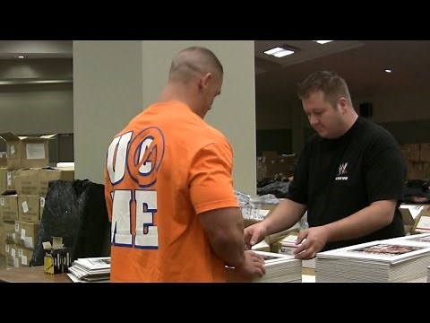 John Cena autographs an insane amount of photos for fans