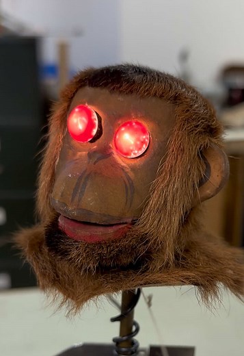 Monkey rising out of a missing coconut. Antique Musical automaton clockwork with red lighting up eyes. Very Scary! More info in ‘Secrets of Automata’.
