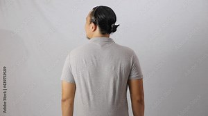 Blank collared shirt mock up template, rear back view, Asian male model wearing plain grey t-shirt isolated on white. Polo tee design mockup presentation