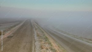 timelapse of fog descending on the cultivated fields covered by frost in the Italian countryside