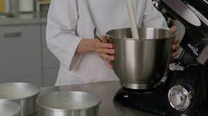 Pastry chef distributing a mixture in baking molds - Free Stock Video
