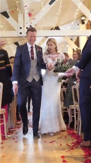 bride and groom walk up the aisle