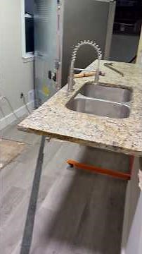 Removing remaining kitchen cabinets and granite countertop.