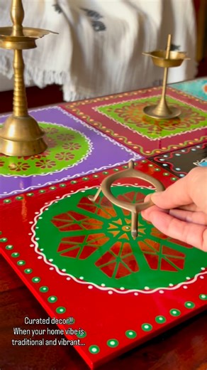 Sumanya Narayanan on Instagram: "When you have some brightly painted plates and some antique brass collections- this seems a perfect display idea!! My center table view for today!! This post is actually inspired by a post I saw a long while ago on a home decor account on the gram and that visual stayed with me:) sadly am not able to recall the account!! Indian home,Pretty homes,Indian home style,Home vibes, Traditional ,Brass collections #traditionalhome #colourfulhomevibe #happinessishandmade #