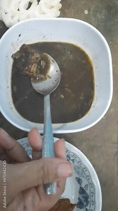 A typical Indonesian dish with black sauce and meat filling is known as Rawon, usually served with white rice and fried tempeh