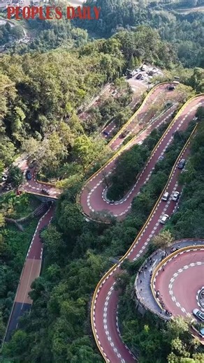 With the narrowest section of less than 4 meters wide, the Aizhai highway is a vital route connecting central China's Hunan Province with southwest China, known for its 13 thrilling bends winding through the lush mountains. | VideoChina