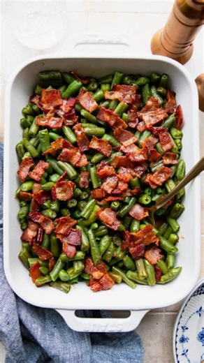 Sweet, smoky, and soaked in buttery bacon glaze. These Arkansas green beans turn even picky eaters into veggie lovers and they fit right in on any table from weeknights to holidays. https://www.theseasonedmom.com/green-beans-bacon/ #vegetablesides #easyrecipes #familydinner #theseasonedmom | The Seasoned Mom - Easy Family Recipes