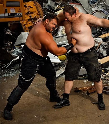 BearMythology on Instagram: "Belgian strongman, Jimmy Laureys, had this promo photo where he gut punches a burly man in an apocalyptic landscape. Unfortunately, this is not from a movie--just a regular photoshoot. 😭 So I used AI to create a mini-clip. AI is slowly learning how body punches work, so I'm doing my part to train it. 😉 #ai #bearmythology #bear #chub #bull #daddy"