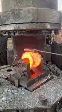 Inside the forging factory Workers cooperate forging bearing rings using heavy industrial air hammer