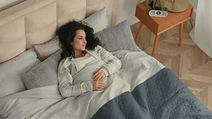 Happy woman stretching lying bed lazy comfortable girl female home hotel rest enjoyment smile good mood relaxed sleepy bedroom satisfaction pleasure weekend glad accommodation awaken daydream mattress