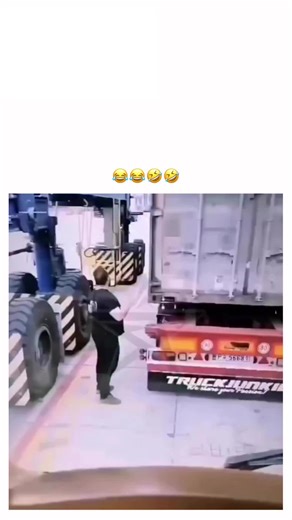 2026 on Instagram: "The video captures a warehouse worker dramatically posing and dancing beside a red semi-trailer truck labeled "Truck Junkie" in an industrial loading dock, showcasing playful energy during routine tasks amid forklifts and shipping containers. Posted by @CameraIncident , an account dedicated to sharing unfiltered, viral camera footage from global incidents, this clip highlights moments of spontaneous joy in blue-collar environments, amassing over 1.8 million views and 7,100 li