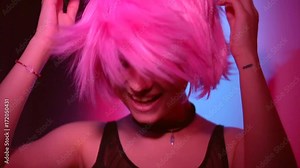 Disco girl dancing on party. Young model woman in colorful bright lights with trendy makeup and haircut. Slow motion 240 fps. 4K UHD video 3840x2160