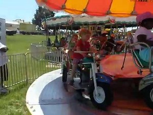 Nathaniel rides the motorcyle at the fair in Raleigh