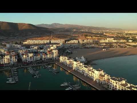 Aerial view of Agadir Marina and city at golden hour, Morocco