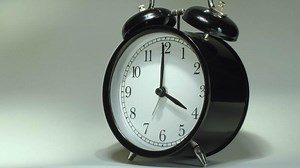 Download A black and white alarm clock on a white background for free