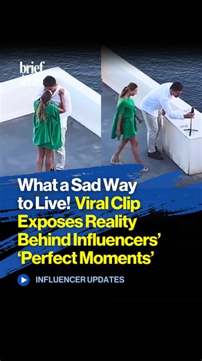 Viral Clip Exposes Reality Behind Influencers’ ‘Perfect Moments’ A viral clip shared on social media shows a young couple in a dramatic romantic embrace on a picturesque clifftop rooftop in Santorini’s iconic white and blue views, creating the impression of an intense, cinematic love moment. The couple clings tightly with the sea in the background, making it look like a raw, emotional scene straight out of a movie. However, the camera soon pans out to reveal a reel shoot nearby, complete with a 