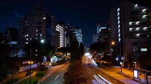 Download A night timelapse of the traffic jam at the city crossing in Tokyo wide shot tilt