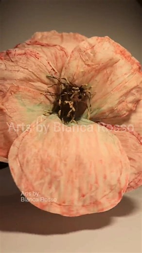 Arts by Blanca Rosso on Instagram: "Learn how to make a giant paper flower using crepe paper for stunning wall decor 🌸 In this DIY tutorial, I dye crepe paper with water and acrylic paint, let it dry, cut the petals, and add thin wire for flexible, realistic shaping. The flower center is made using a barbecue stick and foil (staniol) ball, wrapped in crepe paper and finished with handmade pistils. Each petal is attached one by one using floral green tape, then mounted on a wood wall support for