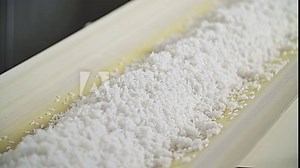 Rice factory. Cleaning and production of rice. Conveyor for packing rice and cereals.