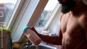 young male making protein shake at home