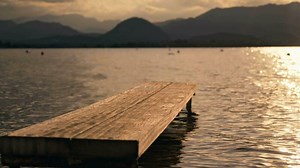 Bridges in the sea, sunset with mountains in the background