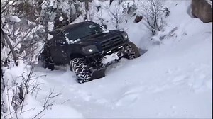Toyota Tacoma climbing a slope with some heavy snow. | Razor4x4