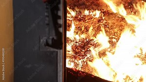 Burning Sawdust in the furnace close up. Fire inside of furnace of boiler. Alternative fuel.