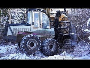 Forwarder Logset 6F logging in beautiful snowy winter forest