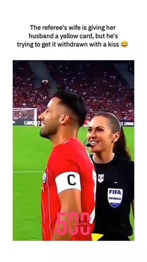 @scrollsports.vibe on Instagram: "This viral video, likely AI-generated, humorously shows a female referee issuing a yellow card to her husband (a player in red kit) on the pitch, with him attempting to appeal via a kiss while she upholds "fairness," blending marital dynamics with football tropes. Posted by @UtdKlay , a dedicated Manchester United and Ronaldo fan, the clip quotes an unrelated betting tip on Man City vs. Newcastle, amplifying its reach to over 9 million views and 6,000 likes with