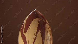 an egg shaped sponge covered with a liquid foundation for deep skin two contrast foundation color mixed and pouring on sponge