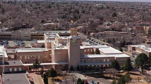 Capture a steady orbital flight of the iconic Southwestern capitol building. This 4K vista emphasizes the monumental scale of the facility in the urban center.
