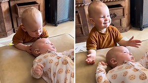 Sweet kid kisses his baby brother