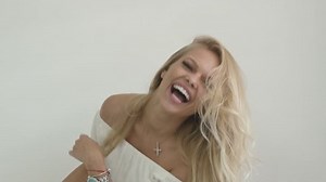 clip-18537068-attractive-blonde-girl-white-top-laughs-plays