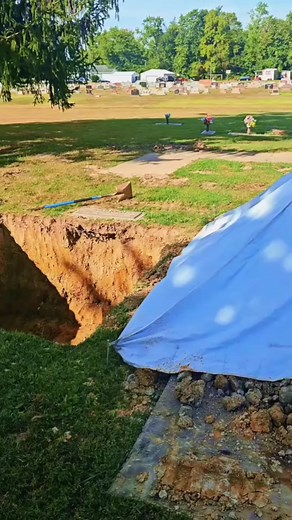 This is the first step of working a side by side committal service with one vault man, and one truck. We asked that the grave be dug 8'x8' so we have plenty of room for our equipment between the vaults. When the service is completed, we will use our wilbert way cables to place the vaults closer to each other, and centered between the headstone. #doubleburial #sidebyside #cemetery #cross #gravesite | Austin Edwards