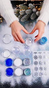 11K views · 93 reactions | ❄️✨ Winter Just Got More Magical… I made these Galaxy Snowflake Ornaments and WOW. They look like frozen universes captured inside a globe. Blue nebula swirls, icy glitter, and the cutest snowflake stickers. They’re so easy: just baking soda, paint, glitter, shake… and winter magic appears instantly. Hang them by a window and the sunlight makes them sparkle like real snow crystals. ❄️ Who wants a tutorial?  | Easy Recipes | Facebook