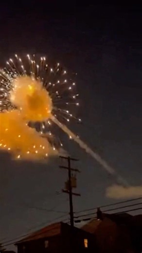 Civilians capture missile intercepted mid-air, exploding across the sky in a fiery blast