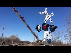 Canadian National train passes by crossing with new WCH type 2 Electronic bell