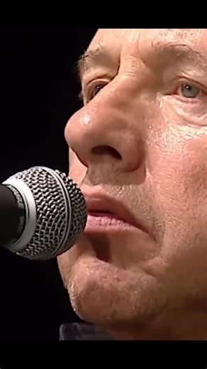 Hits FM - Dá gosto de ouvir! 🎶 on Instagram: "🎸✨ Mark Knopfler — Brothers in Arms (Live in Berlin, Germany • 2009) Quando Mark Knopfler sobe ao palco e os primeiros acordes de “Brothers in Arms” ecoam, o tempo desacelera. Não é apenas uma canção — é um manifesto emocional sobre guerra, perda e humanidade. Lançado em 17 de maio de 1985, Brothers in Arms é o quinto álbum de estúdio do Dire Straits e um divisor de águas na história da música. Foi o primeiro álbum a vender mais de 1 milhão de cóp